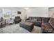 Inviting living room with a plush sectional sofa and ottoman, decorated with neutral tones at 3951 Tersk Dr, Midland, NC 28107