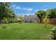 Spacious backyard featuring a green lawn, patio area, and mature trees at 4797 Chesney Nw St, Concord, NC 28027