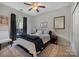 Bedroom with ceiling fan, neutral walls, and window with curtains at 4797 Chesney Nw St, Concord, NC 28027