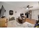 Spacious bonus room with hardwood floors, ceiling fan, oversized recliner and plenty of space for entertaining at 4797 Chesney Nw St, Concord, NC 28027