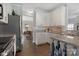 Modern kitchen featuring white cabinets, granite countertops, and stainless appliances at 4797 Chesney Nw St, Concord, NC 28027