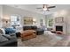 Comfortable living room featuring a ceiling fan, fireplace, and lots of natural light at 4797 Chesney Nw St, Concord, NC 28027