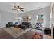 Comfortable living room featuring a ceiling fan, fireplace, and lots of natural light at 4797 Chesney Nw St, Concord, NC 28027