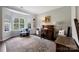 Comfortable living room with vintage desk and large windows overlooking the landscaped yard at 4797 Chesney Nw St, Concord, NC 28027