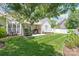 Inviting backyard with a covered patio, lush lawn, and well-maintained landscaping at 502 Roxanne Nw Ct, Concord, NC 28027