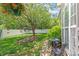 Charming backyard features lush greenery, a small patio, and privacy fencing at 502 Roxanne Nw Ct, Concord, NC 28027