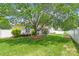 Spacious backyard with manicured lawn, privacy fence, mature tree, and patio at 502 Roxanne Nw Ct, Concord, NC 28027