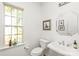 Charming powder room featuring stained glass window and pedestal sink at 502 Roxanne Nw Ct, Concord, NC 28027