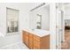 Bright bathroom with a long vanity, updated lighting, and a large mirror at 502 Roxanne Nw Ct, Concord, NC 28027