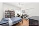 Bedroom with wood floor, closet, and large window for natural light at 502 Roxanne Nw Ct, Concord, NC 28027