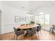 Elegant dining room with natural light, hardwood floors, stylish lighting, and seating for six guests at 502 Roxanne Nw Ct, Concord, NC 28027