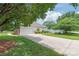 Long driveway leads to a two-car garage, complemented by a well-kept lawn at 502 Roxanne Nw Ct, Concord, NC 28027