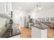 Well-lit kitchen featuring stainless steel appliances and stone countertops at 502 Roxanne Nw Ct, Concord, NC 28027