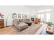 Cozy living room boasting hardwood floors, a sectional sofa, a fireplace, and a bright window at 502 Roxanne Nw Ct, Concord, NC 28027