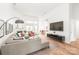 Inviting living room features hardwood floors, a comfortable sofa, modern decor, and an open layout at 502 Roxanne Nw Ct, Concord, NC 28027