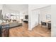Spacious open-concept living room featuring hardwood floors, a comfortable sectional sofa, and modern decor at 502 Roxanne Nw Ct, Concord, NC 28027