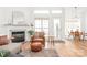 Bright and airy living room featuring hardwood floors, a fireplace, a leather chair, and open access to dining area at 502 Roxanne Nw Ct, Concord, NC 28027