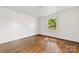 Bedroom showcasing hardwood floors and a window with a neighborhood view at 505 Franklin Ave, Shelby, NC 28150