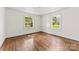 Bedroom boasts hardwood floors, neutral paint and two sunlit windows at 505 Franklin Ave, Shelby, NC 28150