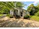View of the home's exterior, showcasing the entrance, garden, and landscaping at 505 Franklin Ave, Shelby, NC 28150
