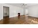 Open living space with a cozy fireplace, ceiling fan, and polished hardwood floors at 505 Franklin Ave, Shelby, NC 28150