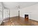 Open-concept living room featuring a cozy fireplace and hardwood floors at 505 Franklin Ave, Shelby, NC 28150