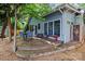 Outdoor living space with patio seating, lush landscaping, and architectural details at 506 Clement Ave, Charlotte, NC 28204