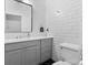 Modern bathroom featuring subway tile, a gray vanity, and contemporary fixtures at 506 Clement Ave, Charlotte, NC 28204