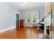 Charming bedroom with hardwood floors, a decorative fireplace, and a bright window at 506 Clement Ave, Charlotte, NC 28204