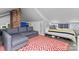Cozy bonus room with a comfortable couch and unique architectural details at 506 Clement Ave, Charlotte, NC 28204