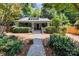 Charming one story home featuring a landscaped front yard with a stone walkway and covered porch at 506 Clement Ave, Charlotte, NC 28204