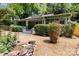 Home exterior featuring lush landscaping and a covered porch with exposed support beams and pillars at 506 Clement Ave, Charlotte, NC 28204