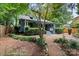 Landscaped front yard with a stone walkway leading to a covered front porch, surrounded by mature trees at 506 Clement Ave, Charlotte, NC 28204