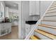 A staircase next to the kitchen featuring white cabinetry, granite countertop and tile floor at 506 Clement Ave, Charlotte, NC 28204