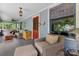 Spacious front porch with seating area, ceiling fan, wood furniture and trim at 506 Clement Ave, Charlotte, NC 28204