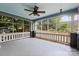Inviting screened porch with ceiling fan, wood flooring and view of the backyard at 506 Clement Ave, Charlotte, NC 28204