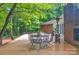 Backyard patio featuring outdoor table and chairs plus mature landscaping and trees, providing lots of shade at 514 Wood St, Troy, NC 27371