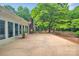 Backyard patio, mature landscaping and plants and a beautiful shade tree at 514 Wood St, Troy, NC 27371