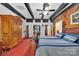 Bedroom with red carpet, wood paneled walls, and large wardrobe at 514 Wood St, Troy, NC 27371