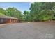 Large driveway leading up to the brick house with mature landscaping at 514 Wood St, Troy, NC 27371