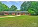 Charming brick home with mature landscaping and a circular driveway at 514 Wood St, Troy, NC 27371