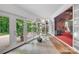 Bright hallway featuring large windows, tiled floors, and ample natural light, creating a seamless transition between spaces at 514 Wood St, Troy, NC 27371
