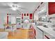 Bright kitchen with white and red accents, ample cabinet space, and modern appliances, offering both style and functionality at 514 Wood St, Troy, NC 27371