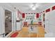 Bright kitchen featuring red and white cabinetry, stainless steel appliances, and a center island at 514 Wood St, Troy, NC 27371