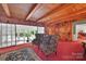 Charming living room with wood paneled walls and exposed wood beams with seamless access to other living spaces at 514 Wood St, Troy, NC 27371
