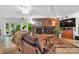Cozy living room with a stone fireplace, comfortable seating, and access to the outdoors, creating a warm and inviting space at 514 Wood St, Troy, NC 27371