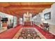 Spacious living room features exposed wood beams, a chandelier, and a large decorative rug at 514 Wood St, Troy, NC 27371