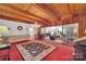 Open living room featuring wood beams, chandelier, and seamless flow into another living space at 514 Wood St, Troy, NC 27371