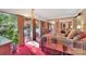 Main bedroom with chandelier, large windows, and red carpet at 514 Wood St, Troy, NC 27371