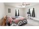 Bedroom with neutral walls, ceiling fan, and two windows at 515 Myrtle Ave, Chester, SC 29706